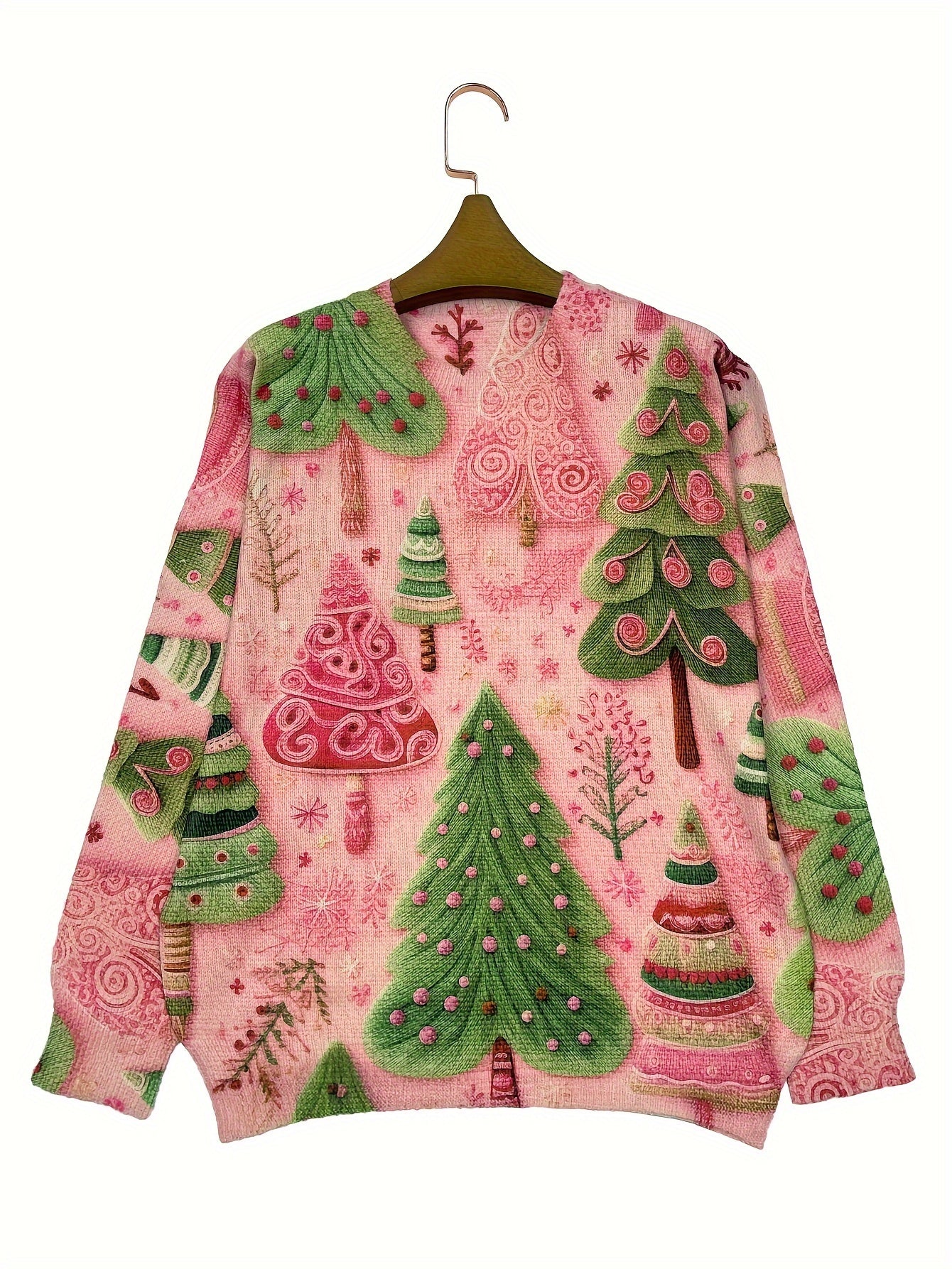 Christmas-themed sweater with green and pink trees and pink background on a hanger