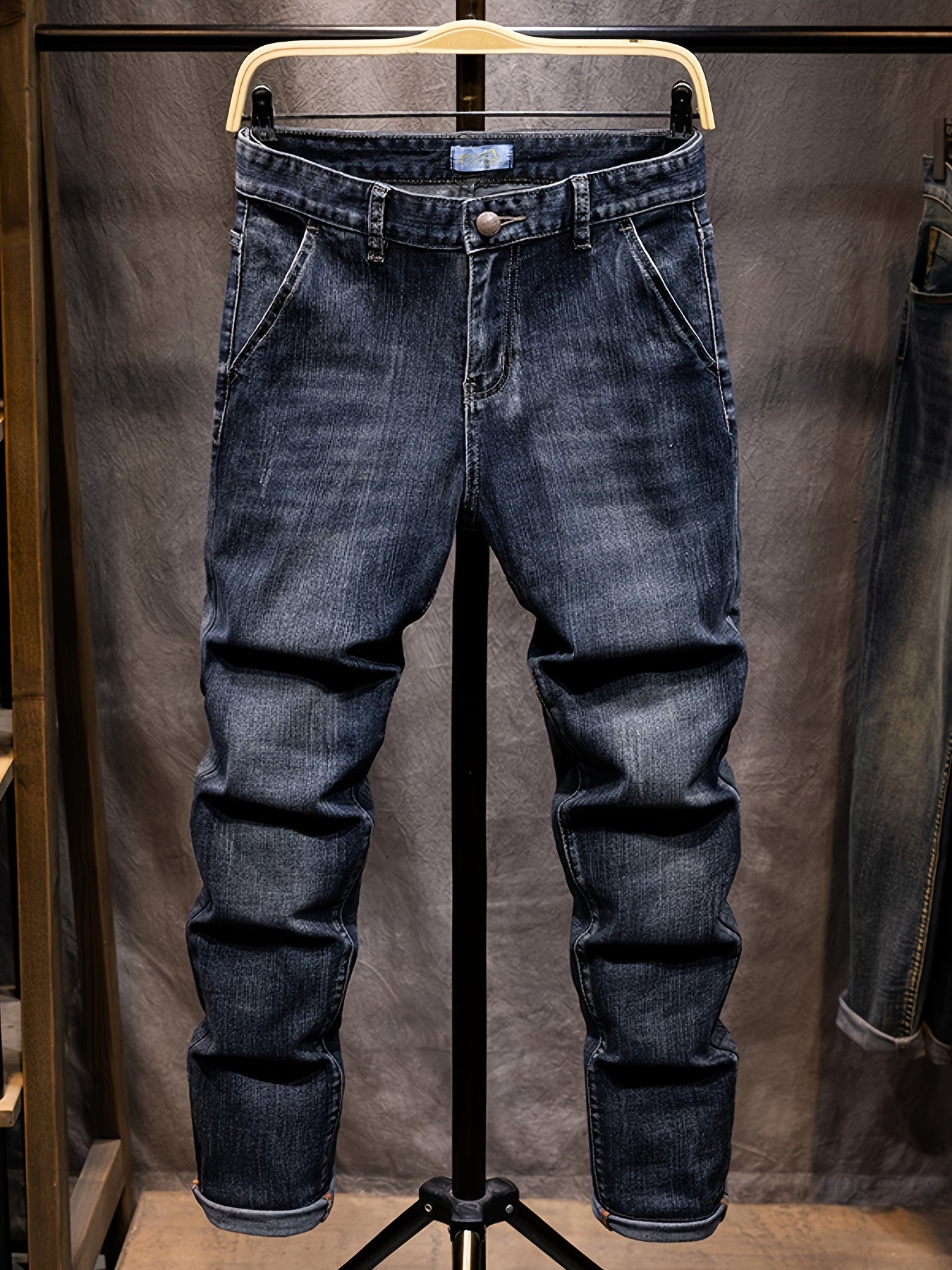 Blue jeans on a mannequin against a plain background